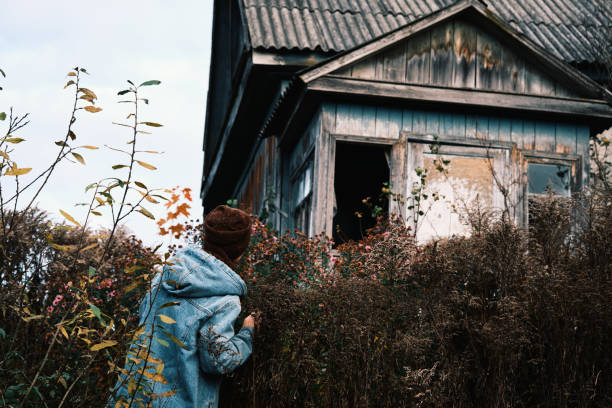 istock Female tourist is exploring abandoned ruined house 2181696715