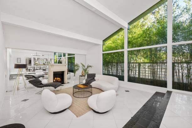 istock Modern living room with white furniture, fireplace, and open layout 2181696849