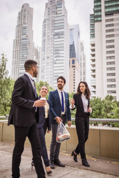 istock Business Team Walking Outdoors with City Skyline Background 2181698181