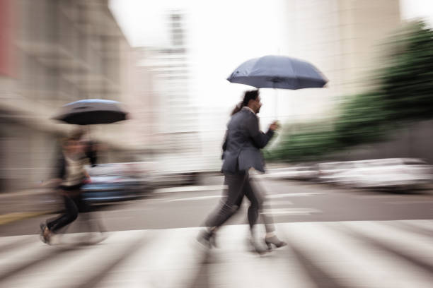 istock People walking with umbrellas in city 2181698266