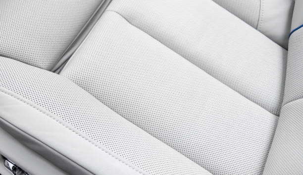 istock White leather interior of the luxury modern car. Perforated white leather comfortable seats with stitching. Modern car interior details. 2181698826