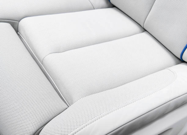 istock White leather interior of the luxury modern car. Perforated white leather comfortable seats with stitching. Modern car interior details. 2181699126