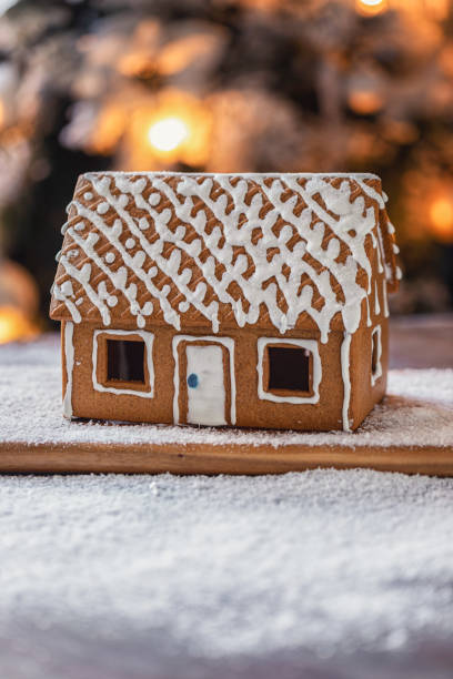 istock Homemade gingerbread house in front of Christmas tree 2181703709