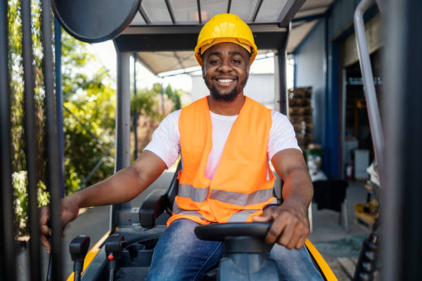 istock Front view of smiling interracial industry worker driving forklift. 2181707424