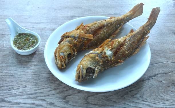 istock deep fried croaker fish dipping Thai spicy seafood sauce 2181707620