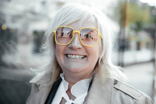 istock Smiling elderly woman with yellow sunglasses 2181708976
