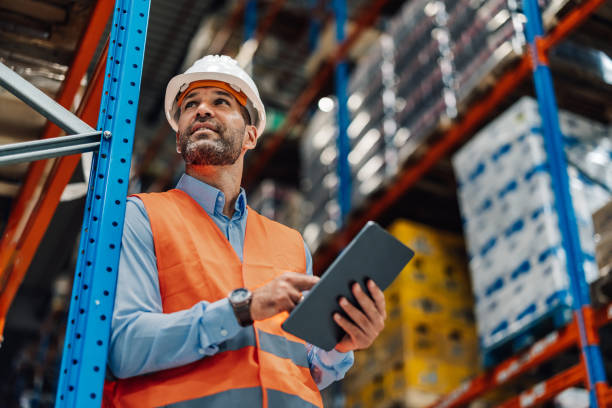 warehouse manager using digital tablet and controlling inventory - lagerlokal bildbanksfoton och bilder