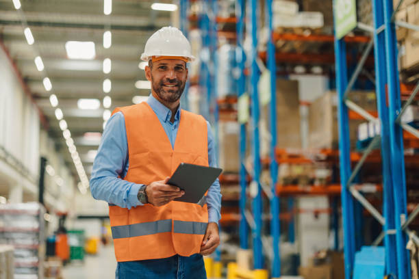istock Warehouse manager holding digital tablet and smiling at logistics center 2181711973