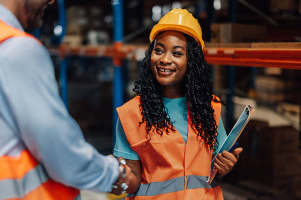 istock Female warehouse worker shaking hands with manager 2181712000