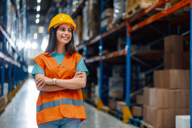 istock Female warehouse worker smiling with crossed arms 2181712014