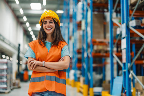 istock Female warehouse worker smiling with crossed arms 2181712020