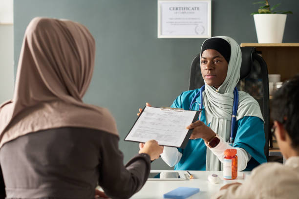 istock Muslim Doctor Consulting Patients in Her Office 2181714228