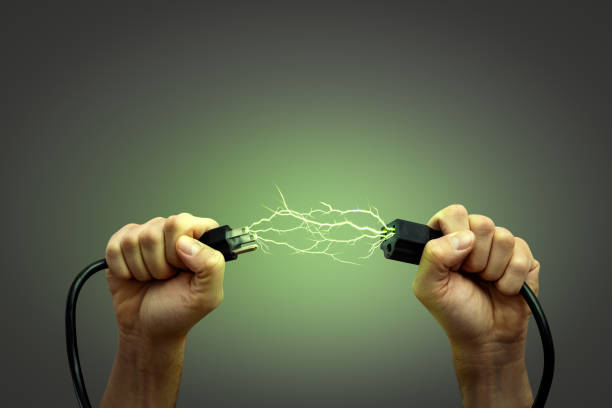 istock Hands Holding US Power Cord Symbolizing Green Energy 2181714658