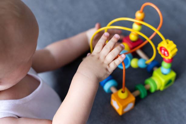 istock Little child playing with educational toy, Cognitive skills, Montessori activity. Selective focus. 2181715517