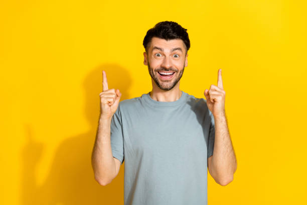 istock Photo of funky excited positive brunet man student genius idea solution cash problem eureka success fingers pointing up isolated on yellow color background 2181717401