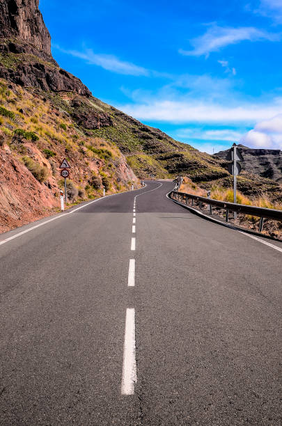 istock A long, straight road with a white line down the middle 2181717508