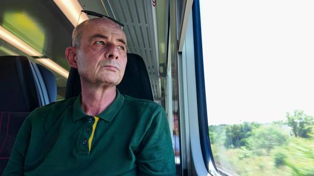 istock A man on a train. Older man commutes to work. Concept of daily routine of commute to work 2181719042