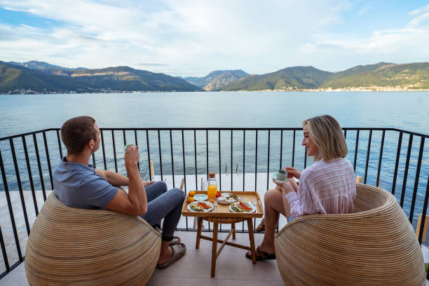 istock Breakfast with a view: couple sharing a meal overlooking the sea 2181719707