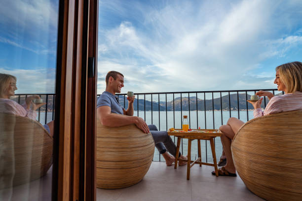 istock Breakfast with a view: couple sharing a meal overlooking the sea 2181719922