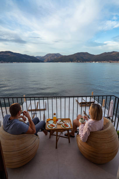 istock Breakfast with a view: couple sharing a meal overlooking the sea 2181720155