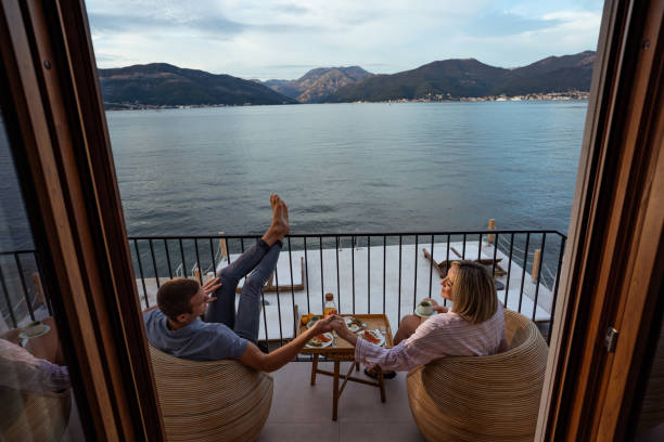 istock Breakfast with a view: couple sharing a meal overlooking the sea 2181720160