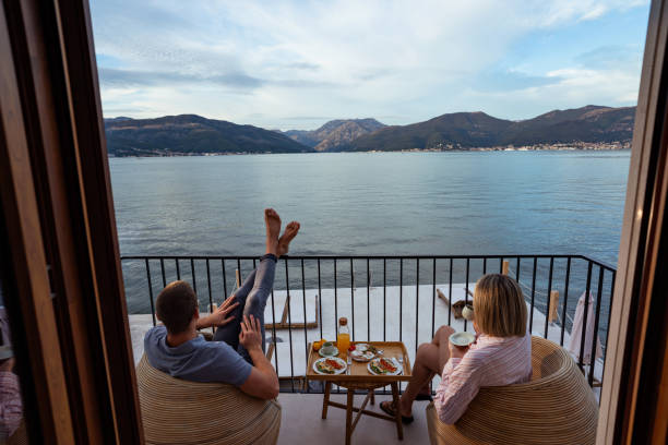 istock Breakfast with a view: couple sharing a meal overlooking the sea 2181720161