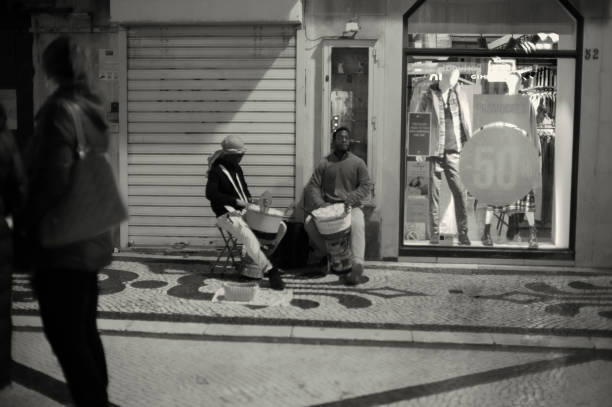 Lisbon, Portugal - December 23, 2023: A couple of street musicians perform at the Rua Augusta street in Lisbon downtown.