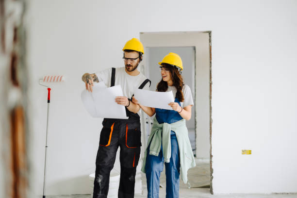 istock Man and woman construction workers in protection gear holding documents ant talking on indoor building construction site 2181724151