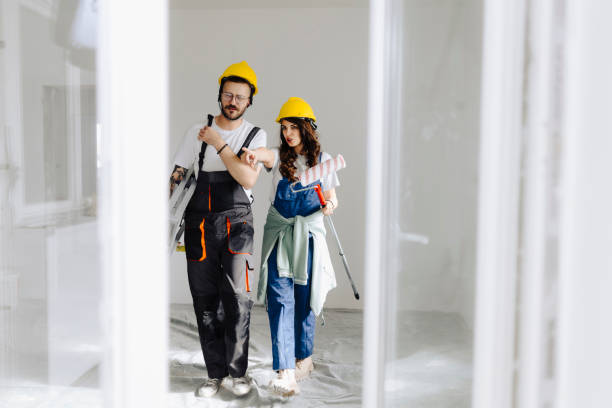 istock Young workers with painting tools indoors. Room renovation 2181724169