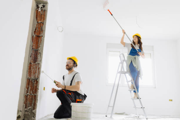 istock Young workers with painting tools indoors. Room renovation 2181724350
