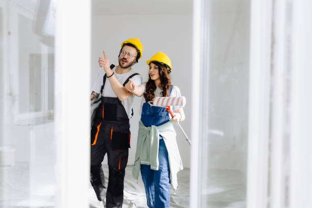 istock Young workers with painting tools indoors. Room renovation 2181724435