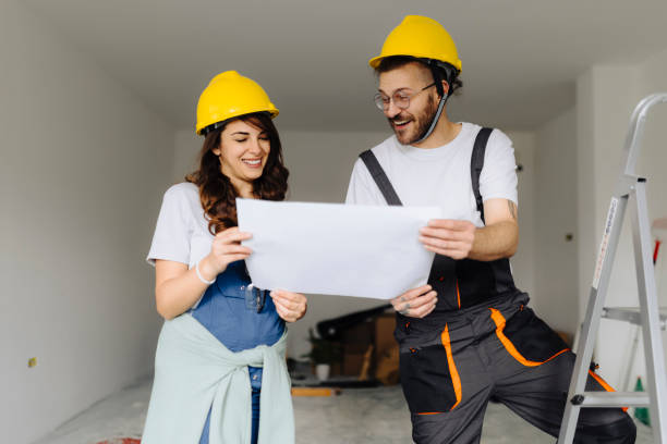 istock Man and woman construction workers in protection gear holding documents ant talking on indoor building construction site 2181724725