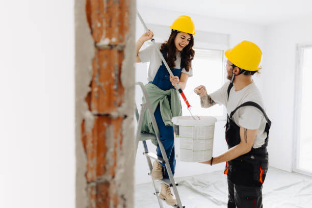 istock Young workers with painting tools indoors. Room renovation 2181724826