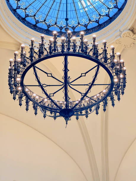 A large, ornate chandelier illuminates the space, showcasing intricate metalwork and a multitude of lights.