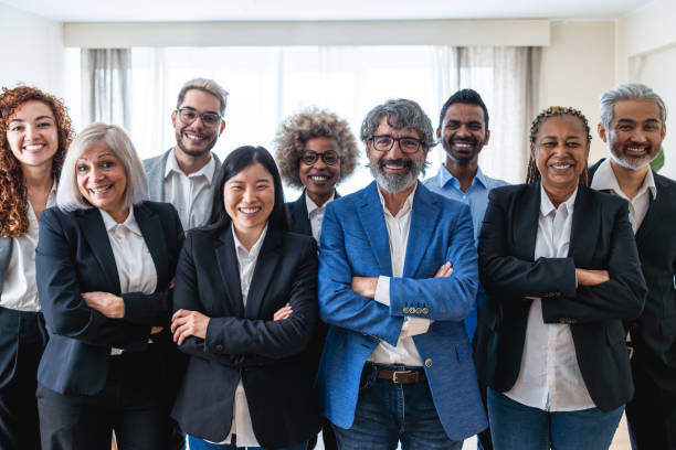 istock Multi generational workers smiling in front of camera inside business office - Multiracial entrepreneur and teamwork concept - Main focus on man with glasses 2181725185