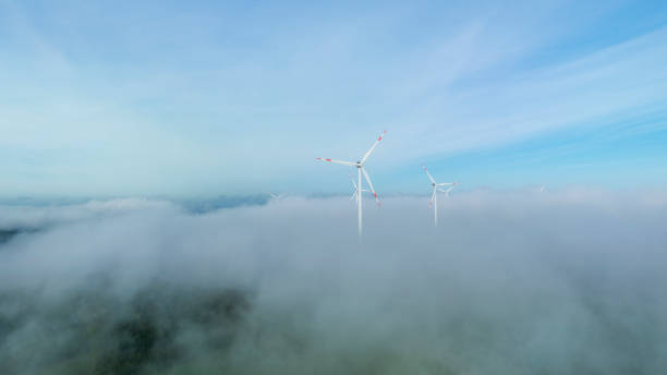 istock Wind turbines, fog and clouds on hills 2181725328