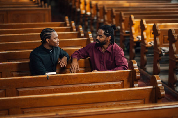 istock Priest listening to man talking about problems in church 2181726528