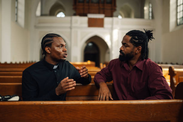 istock Priest listening to man talking about problems in church 2181726534