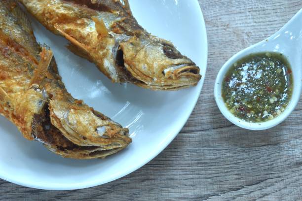 istock deep fried croaker fish dipping Thai spicy seafood sauce 2181726537