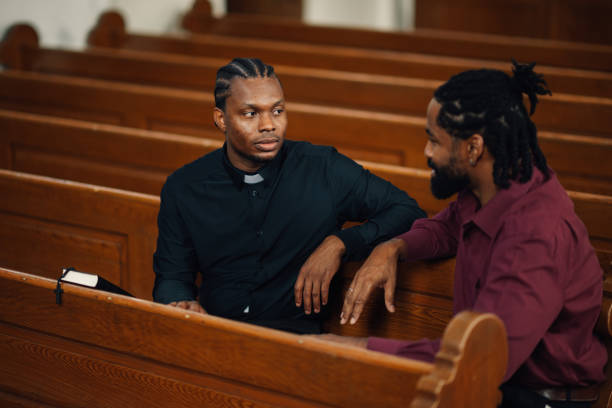istock Priest listening to man talking about problems in church 2181726538