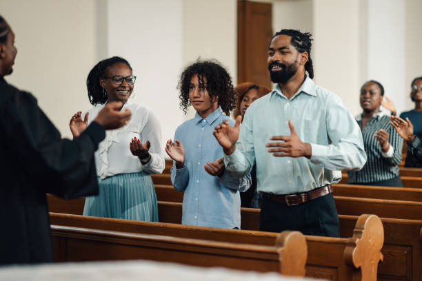 istock Group of people clapping and singing at a church service 2181729074