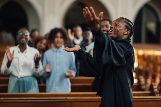 istock Preacher delivering passionate sermon to diverse congregation in church 2181729078