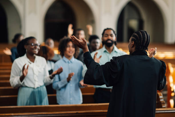 istock African american preacher leading congregation in prayer 2181729091