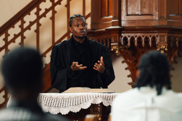 istock Young priest giving sermon during church service 2181729097