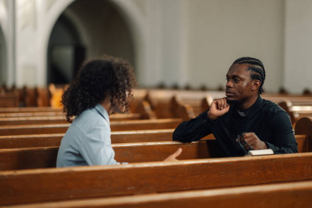 istock Priest listening to young man talking about problems in church 2181729146