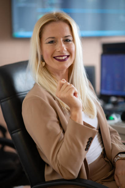 istock A businesswoman sitting in a programmer's office surrounded by computers 2181730059