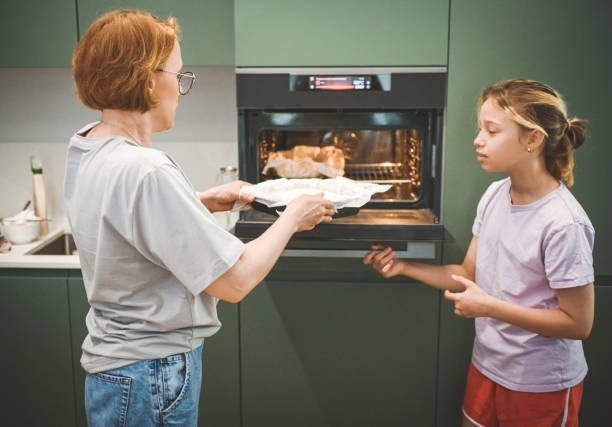 istock Mom and daughter cooks in the kitchen 2181730067