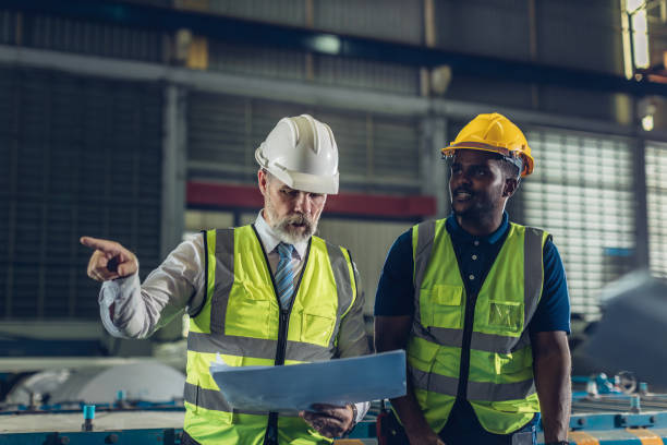 istock Foreman or worker work at factory site check up machine or products in site. 2181731977