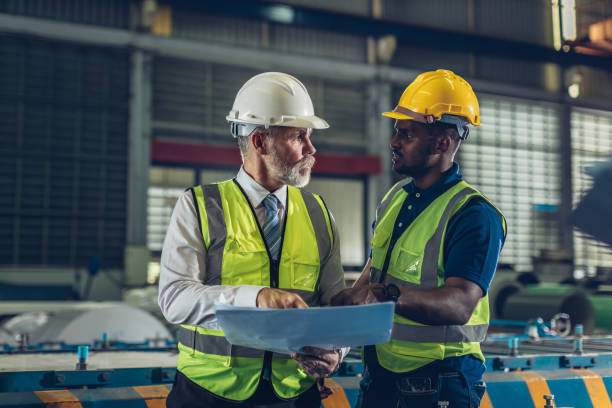 istock Foreman or worker work at factory site check up machine or products in site. 2181731979