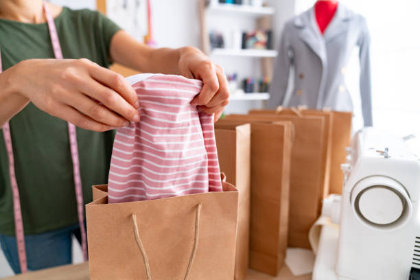 istock Fashion entrepreneur packing orders for her e-commerce business 2181733124